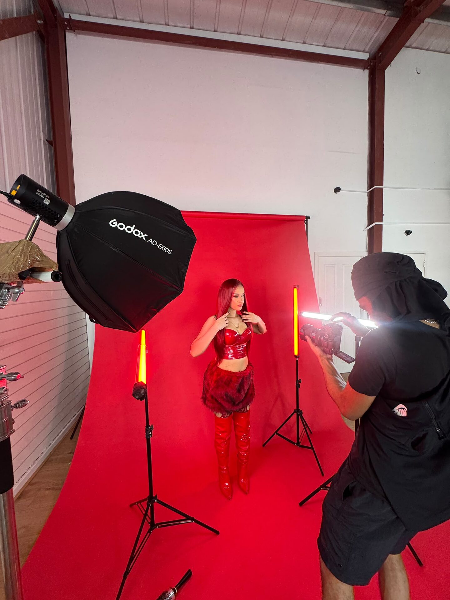 Wide view of the red backdrop shoot, softbox on the left and red tube lights either side